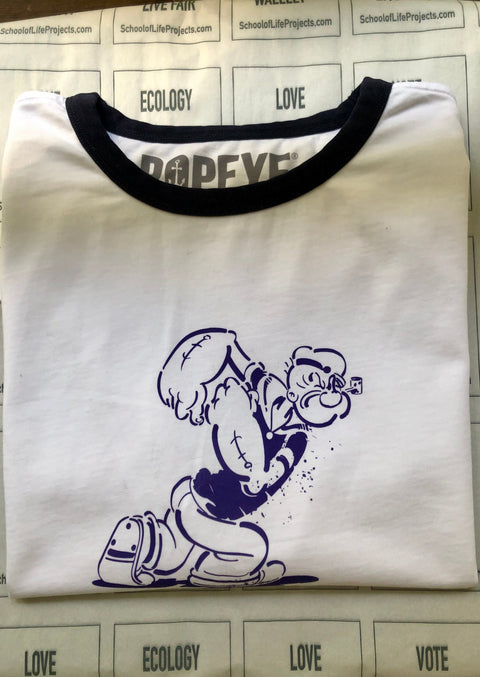 BRIGHT WHITE RINGER TEE WITH NAVY TRIMS. GRUNGY MARCHING POPEYE AS A CHESTPRINT IN JEANSBLUE
