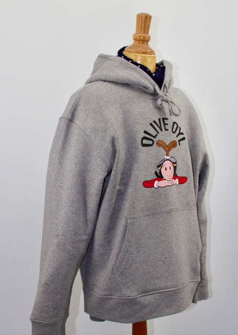 SIDEVIEW OF HOODED SWEAT, PART OF THE COLLECTION OF SCHOOLOFLIFEPROJECTS. THE CHESTARTWORK IS A MULTI COLOR GRAPHIC OF OLIVE OYLE, POPEYE'S GIRLFRIEND