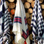 THREE BEAUTIFUL PONCHO'S HANGING ON A WALL OF WOODLOGS IN NATIONAL PARK SERRA DA ESTRELA. FROM THE RIGHT TO THE LEFT; PONCHO BIG KOMPEL, STRIPED PONCHO SAO LOURENCO AND PONCHO KOMPEL